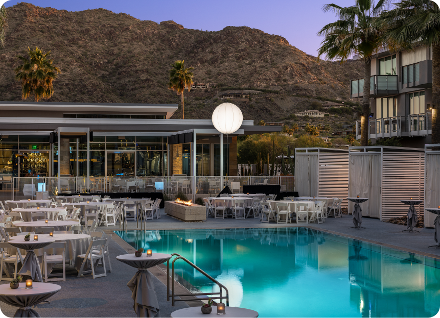 Mountain Shadows Resort pool at dusk with Camelback Mountain in the background