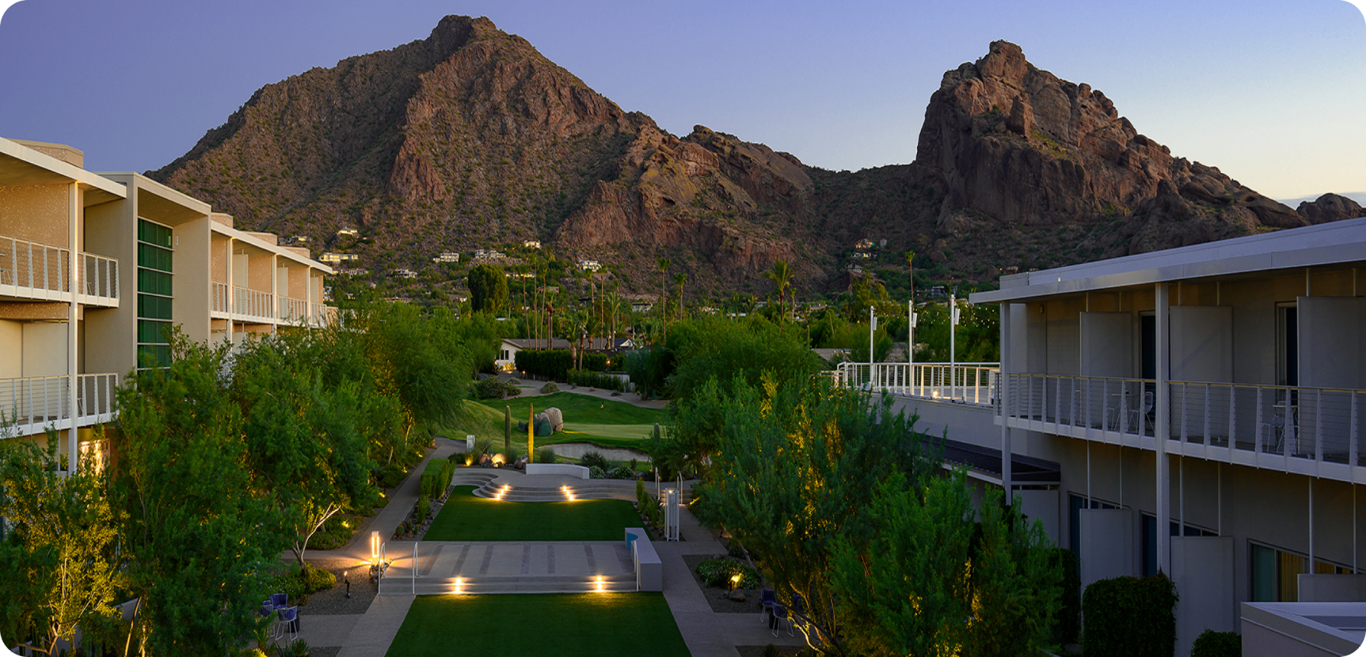 Mountain Shadows Resort lawn at dusk with Camelback Mountain in the background